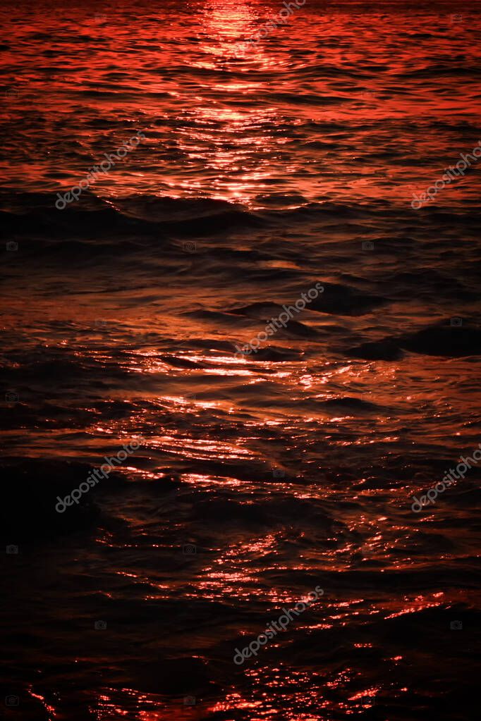Abstract gradient texture of sunset reflection in the sea water