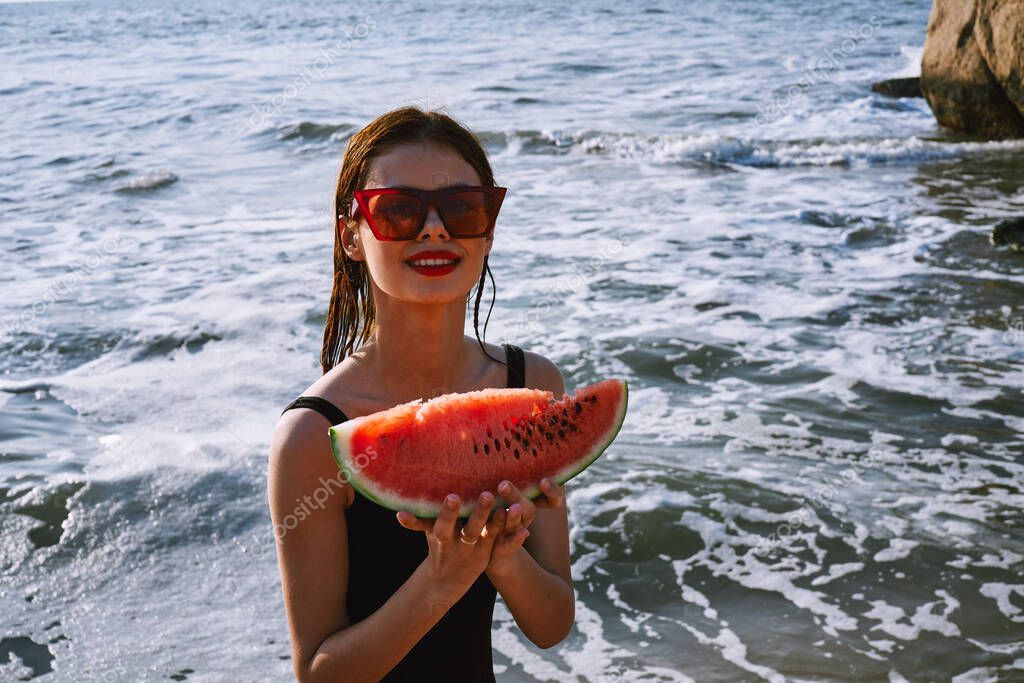 Cheerful pretty woman in black swimsuit watermelon fashion travel. High quality photo model released