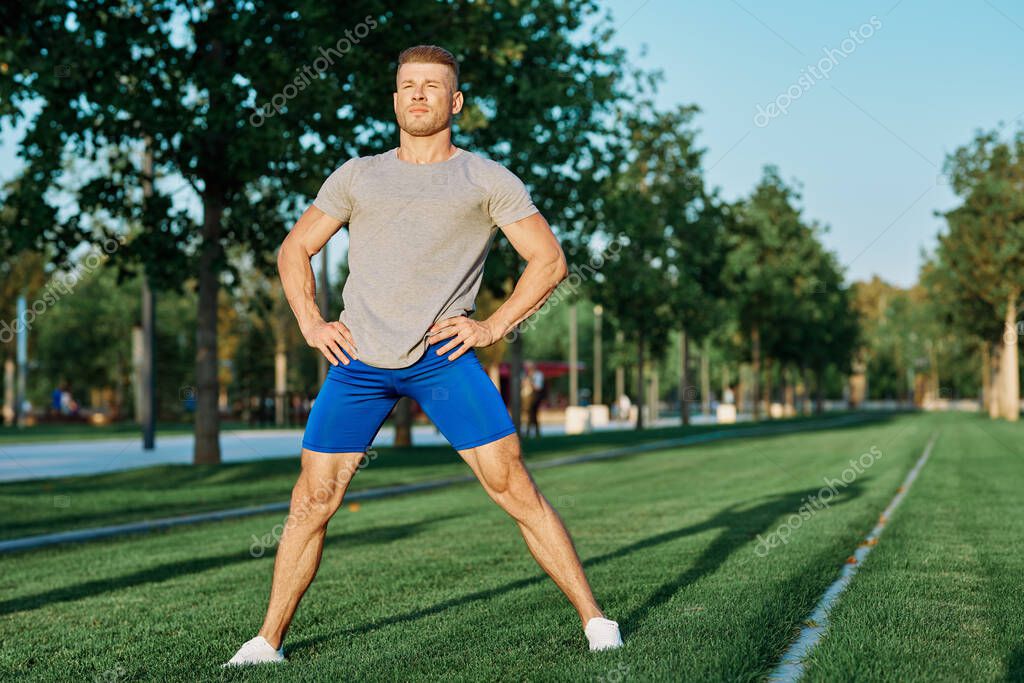 Sporty man in the park on the lawn exercise lifestyle. High quality photo model released