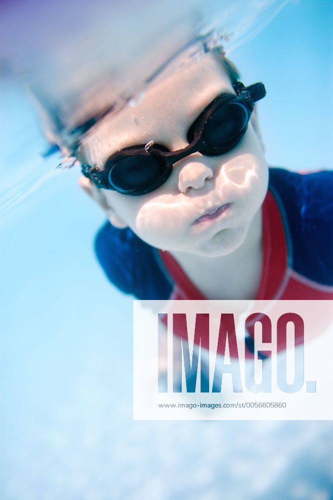 Portrait of cute 6 years old boy swimming underwater - McPSHA