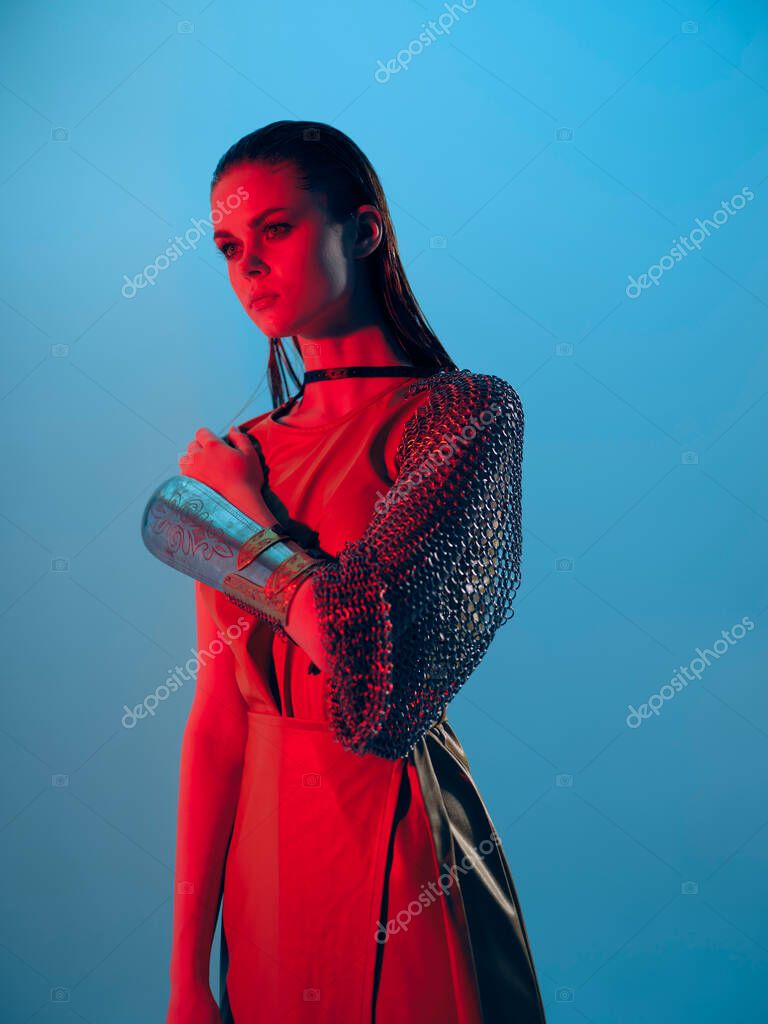 Young woman in dress arm in armor chain mail protection unaltered. High quality photo model released