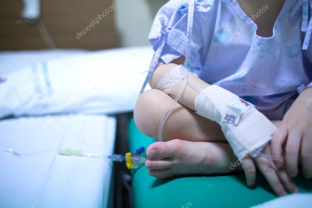 Sick child on a receiving a saline solution in hospital