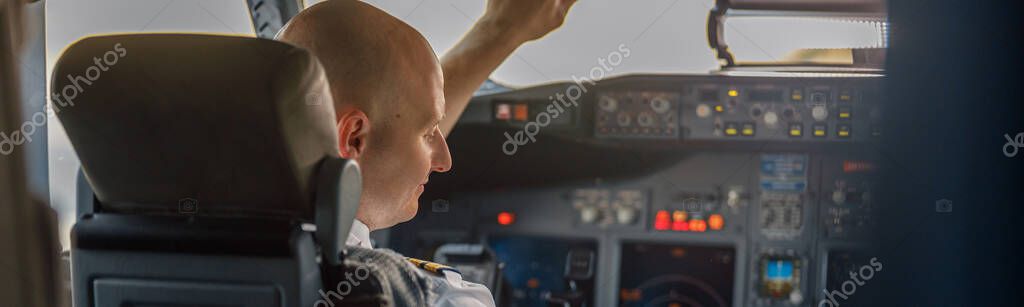 Focused professional pilot sitting in an airplane cabin, ready for takeoff. Aircraft, aircrew, occupation concept model released