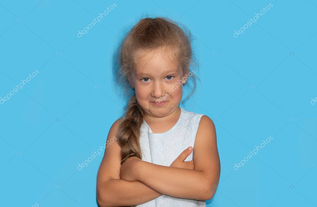 Mischievous little gir with curly hairl making sarcastic face, like seriously, perfect use for memes. A portrait of an caucasian beautiful girl. model released