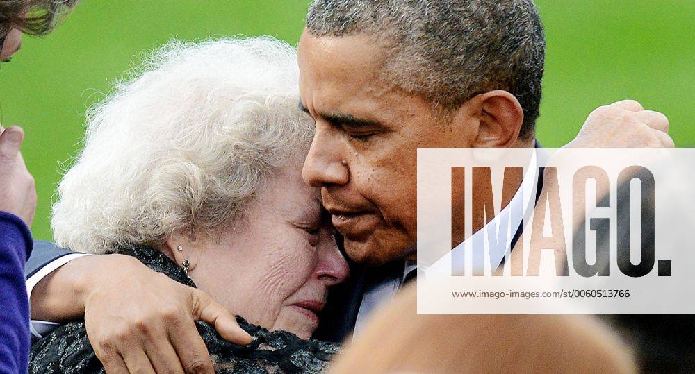 President Barack Obama comforts families of the victims at a memorial for the victims of the Washington Navy Yard shooting at the Marine Barracks, September 22, 2013 in Washington, D.C. Twelve people were killed at the Navy Yard by a naval contractor on Monday, September 16, 2013. WAX20130922167