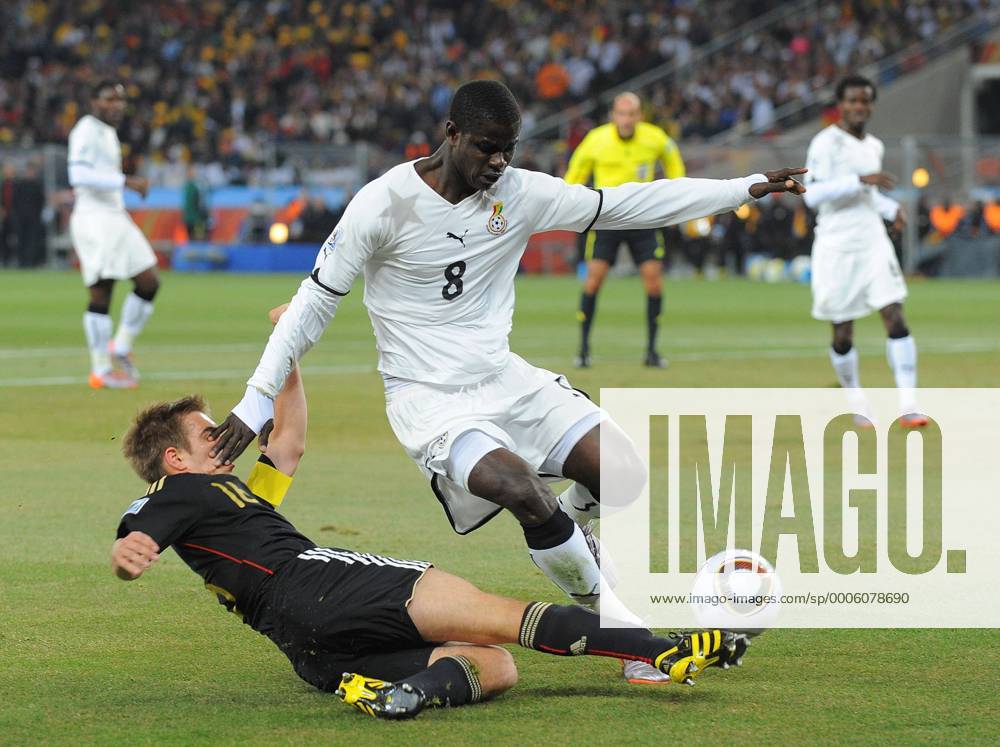 Philipp Lahm (L) of Germany gets in a cross past Jonathan Mensah of Ghana FIFA World Cup 2010 Group D Ghana v Germany 23rd June, 2010 .