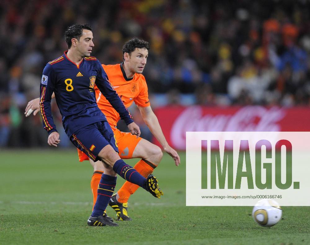 Xavi Hernandez of Spain and Mark Van Bommel of Netherlands FIFA World Cup 2010 Final Netherlands (orange) vs Spain (blue) 11th July, 2010 .