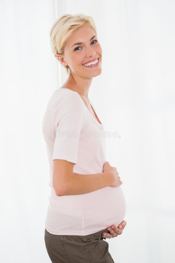 Portrait of smiling blonde pregnant, Portrait of smiling blonde pregnant with white background model released