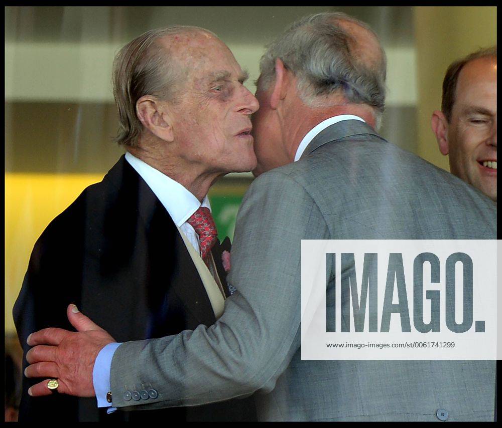 Image ©Licensed to i-Images Picture Agency. 18 06 2014. Ascot, United Kingdom. The Duke of Edinburgh kisses his son The Prince of Wales in the Royal Box on Day 2 of Royal Ascot at Ascot Racecourse. AndrewxParsonsx xi-Images IIM-2483-0036