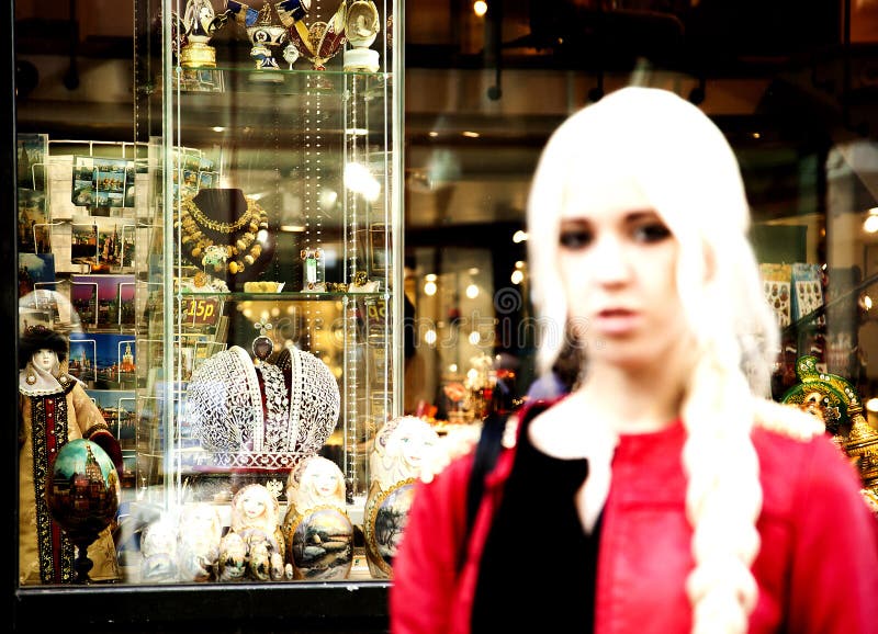 Young blond woman standing next to a souvenir shop on the old Ar, Young blond woman standing next to a souvenir shop on the old Arbat,