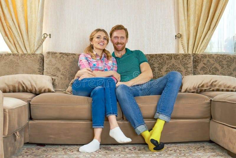 Happy couple sitting on sofa., Happy couple sitting on sofa. Woman and men indoors. Psychology of relationships.