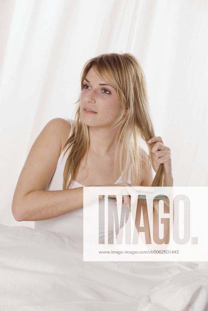 Blonde woman brushing her hair, portrait model released LDF00598