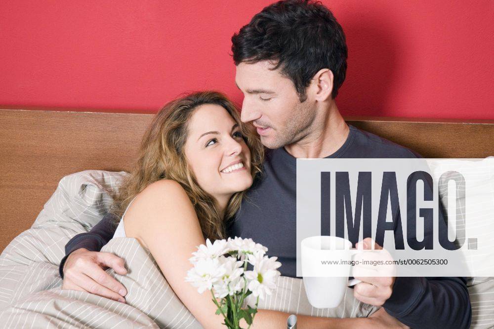 Young couple having breakfast in bed model released property released NHF00983