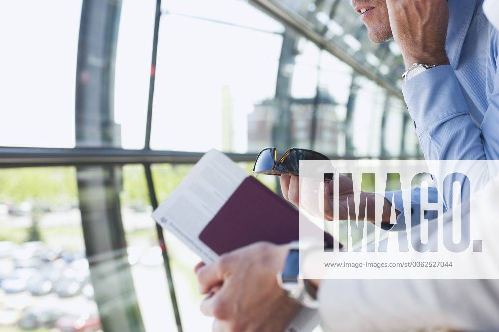 Germany, Leipzig-Halle, Airport, Businessman using mobile phone, person in foreground model released property released WESTF12032