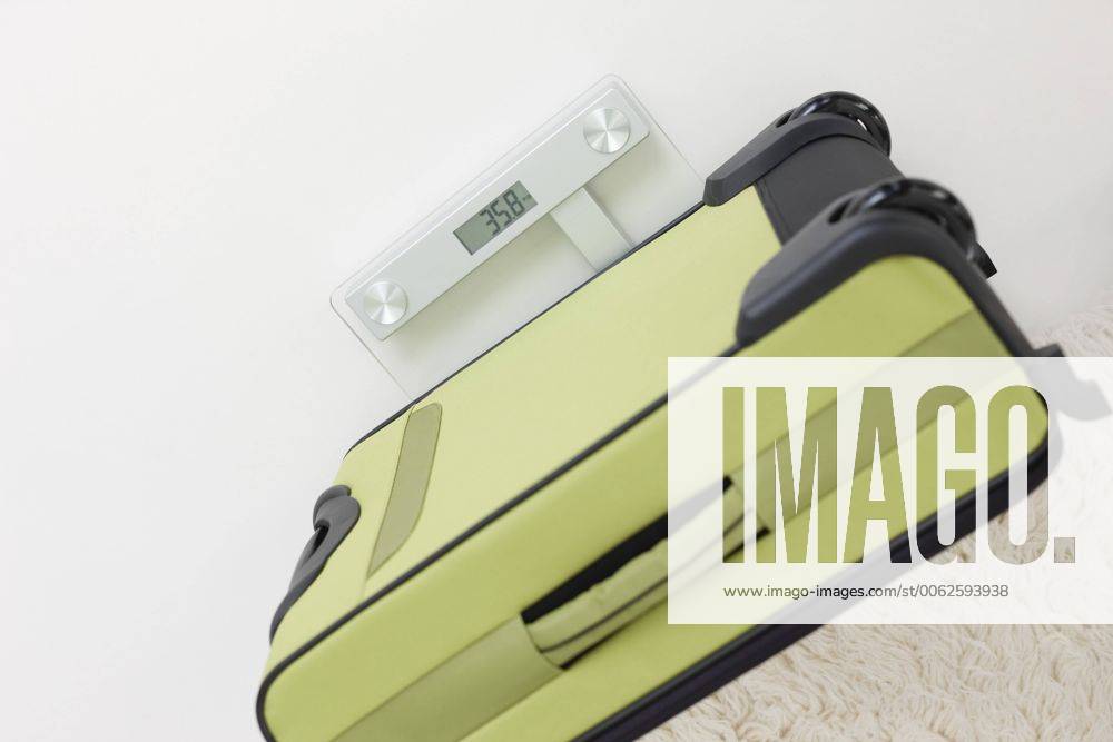 Germany, Leipzig, Heavy suitcase on scales in apartment property released WESTF018404