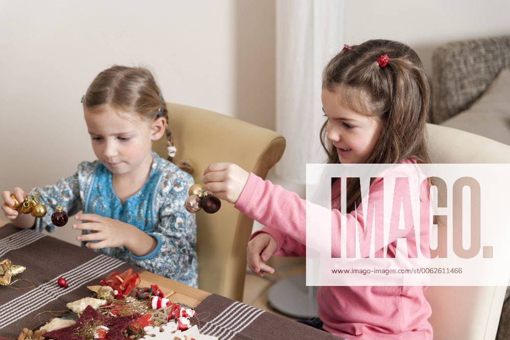 Two little girls tinkering Christmas decoration model released ECF000635