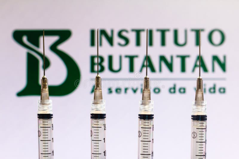 Brazil. In this photo illustration various medical syringes is seen with Instituto Butantan company logo, December 4, 2020, Brazil. In this photo illustration various medical syringes is seen with Instituto Butantan company logo displayed on a screen in the background.