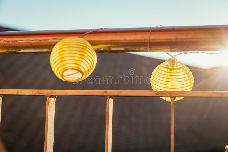 Summer feeling on the balcony: Close up of lampions, Close up of summer lampions on a balcony, leisure time in the summer holidays, light, feeling, party, outdoors, decoration, concept, lifestyle, garden, cosy, weekend, evening, relax, home, summertime, festival, homelike, ease, relaxation, bright, celebration, youth, season, object, invitation, music, fun, lighting, design, celebrate, decorative, vintage, colors, text, space, carnival, copy, sphere