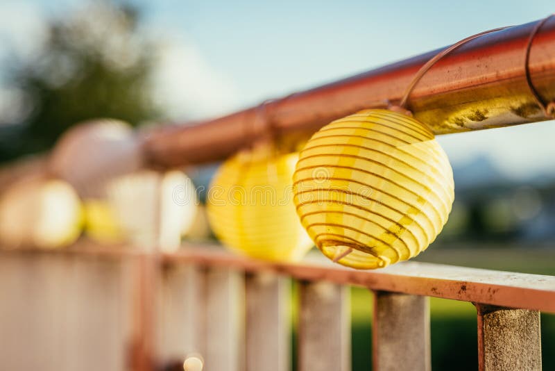 Summer feeling on the balcony: Close up of lampions, Close up of summer lampions on a balcony, leisure time in the summer holidays, light, feeling, party, outdoors, decoration, concept, lifestyle, garden, cosy, weekend, evening, relax, home, summertime, festival, homelike, ease, relaxation, bright, celebration, youth, season, object, invitation, music, fun, lighting, design, celebrate, decorative, vintage, colors, text, space, carnival, copy, sphere