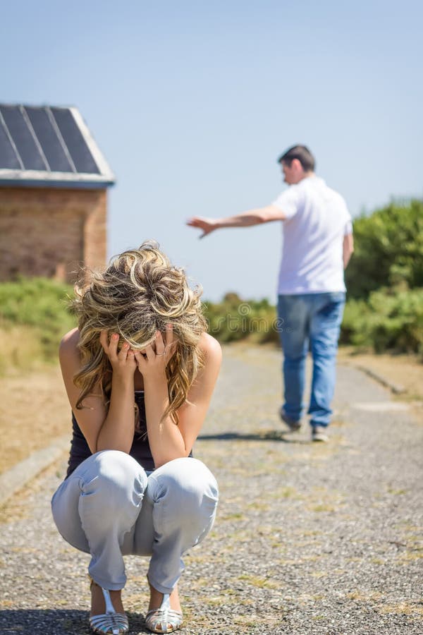 Unhappy man and angry woman leaving after quarrel, Unhappy women in focus crying and angry men leaving on the background after quarrel