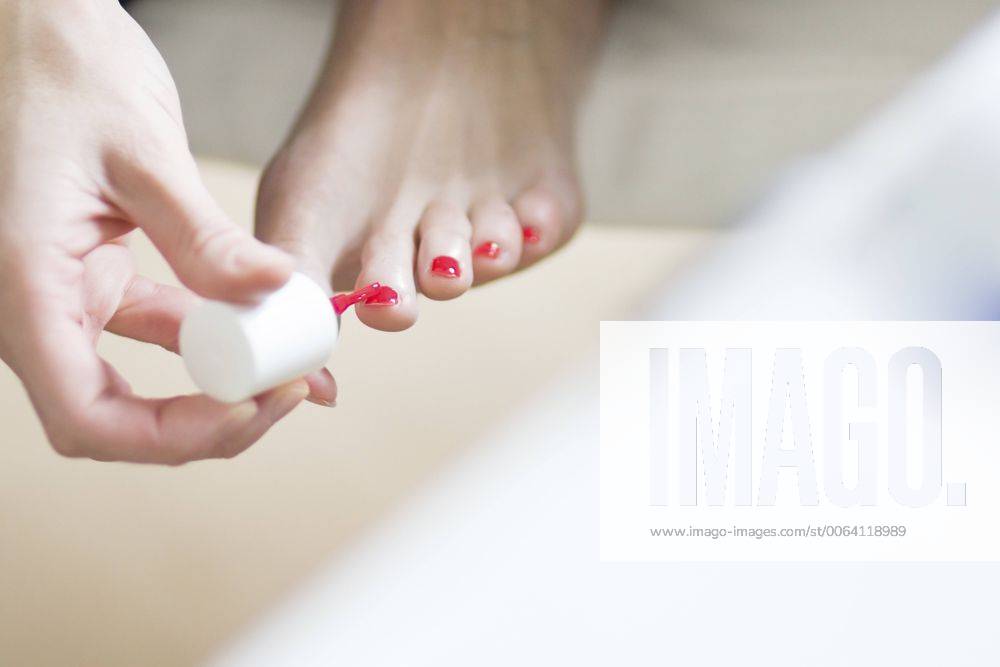 Woman painting her toenails pink model released Symbolfoto CHPF000042