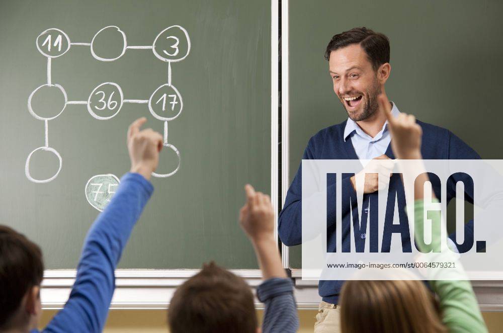 Happy teacher at blackboard with arithmetic problem model released Symbolfoto property released MFRF000109