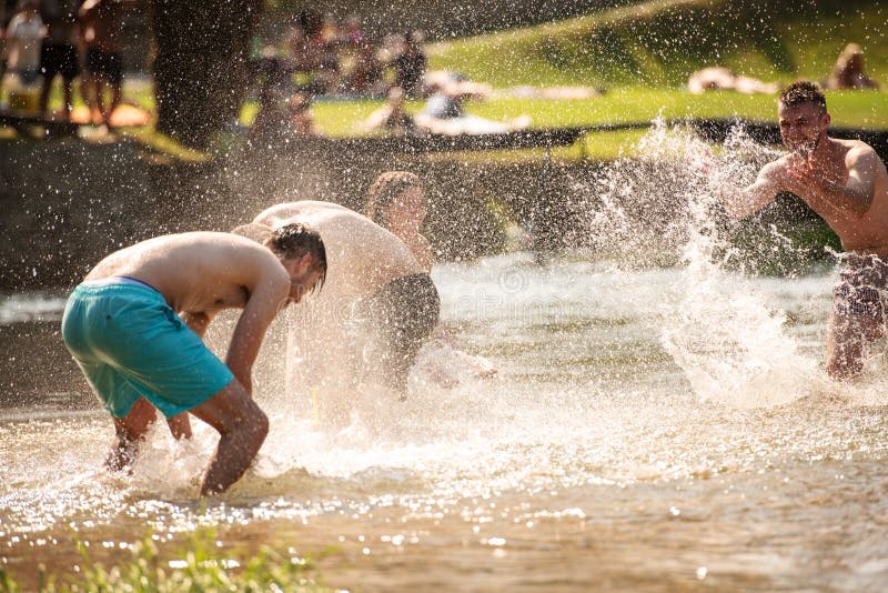 Summer joy friends having fun on river, Summer joy group of happy friends having fun while running and splashing on river
