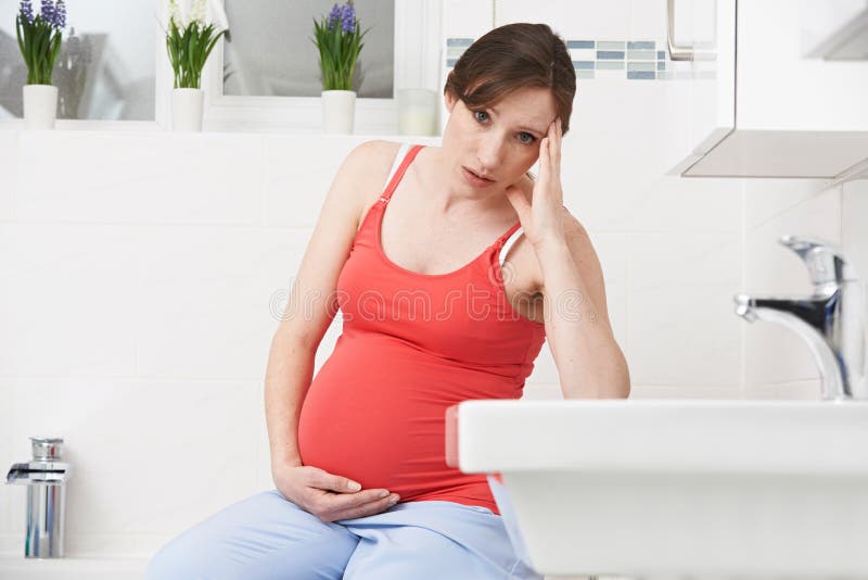 Pregnant Woman Suffering With Morning Sickness In Bathroom, Pregnant Woman Suffers With Morning Sickness In Bathroom model released