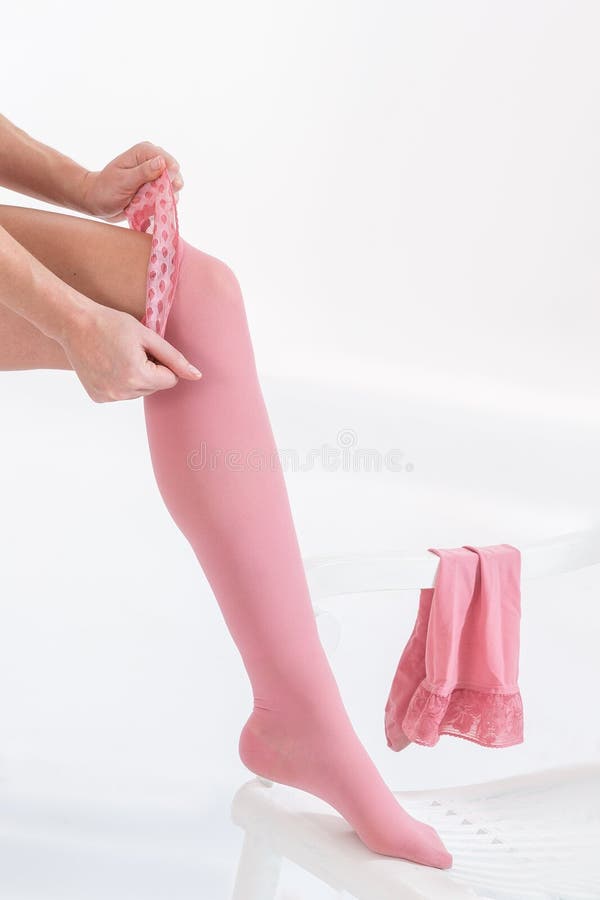 Woman putting thrombosis stockings on, Woman putting anti-trombolic stockings on