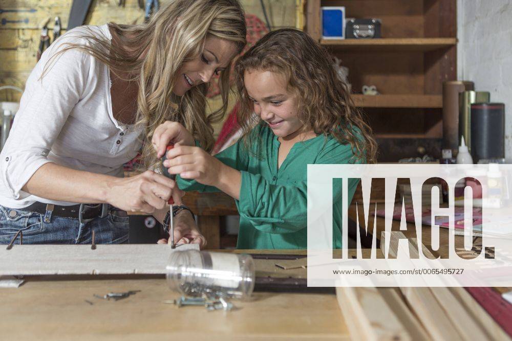 Mother and daughter doing crafts in home garage model released Symbolfoto property released ZEF004856