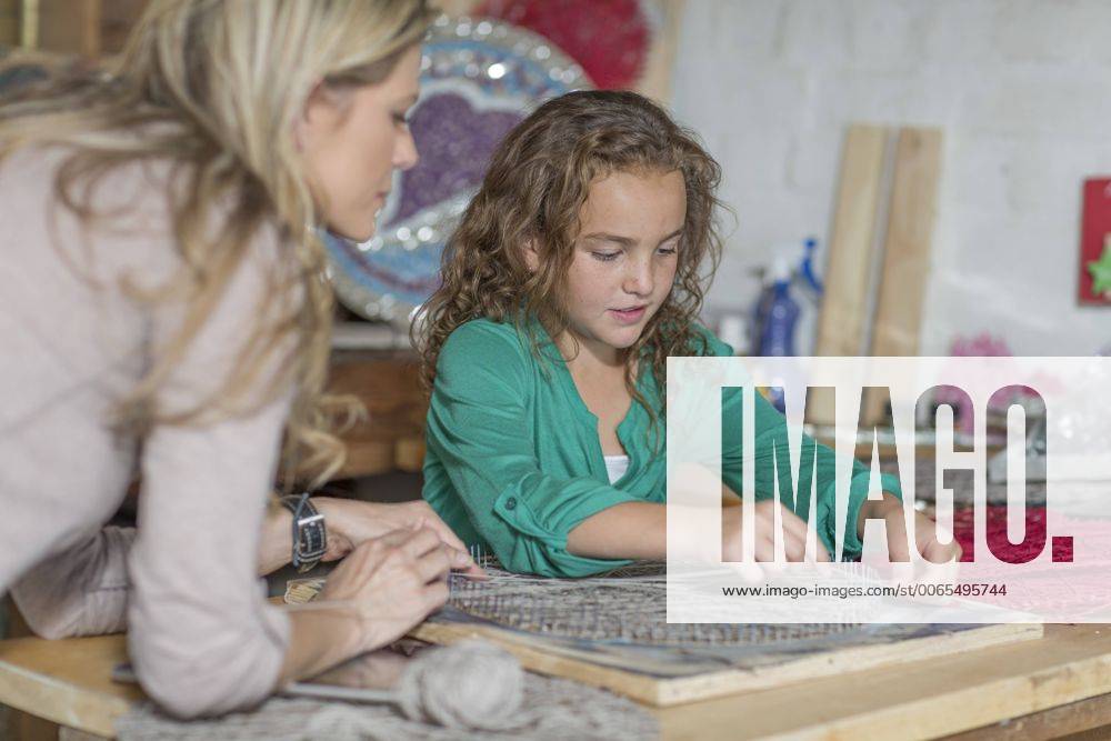 Mother and daughter doing crafts in home garage model released Symbolfoto property released ZEF004867