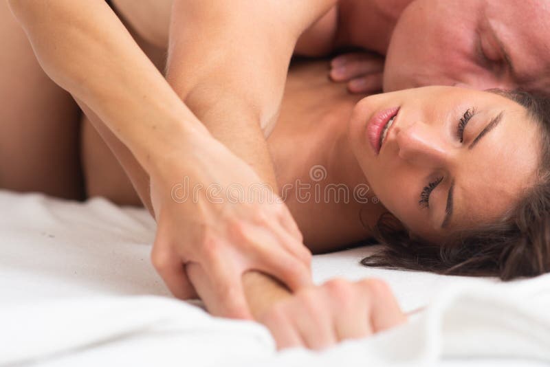 Kissing couple in bed. Couple sex. Sensual seductive desire. Young lovers. Kamasutra positions. Erotic moments., Kissing couple in bed. Couple sex. Sensual seductive desire. Young lovers. Kamasutra positions. Erotic moments