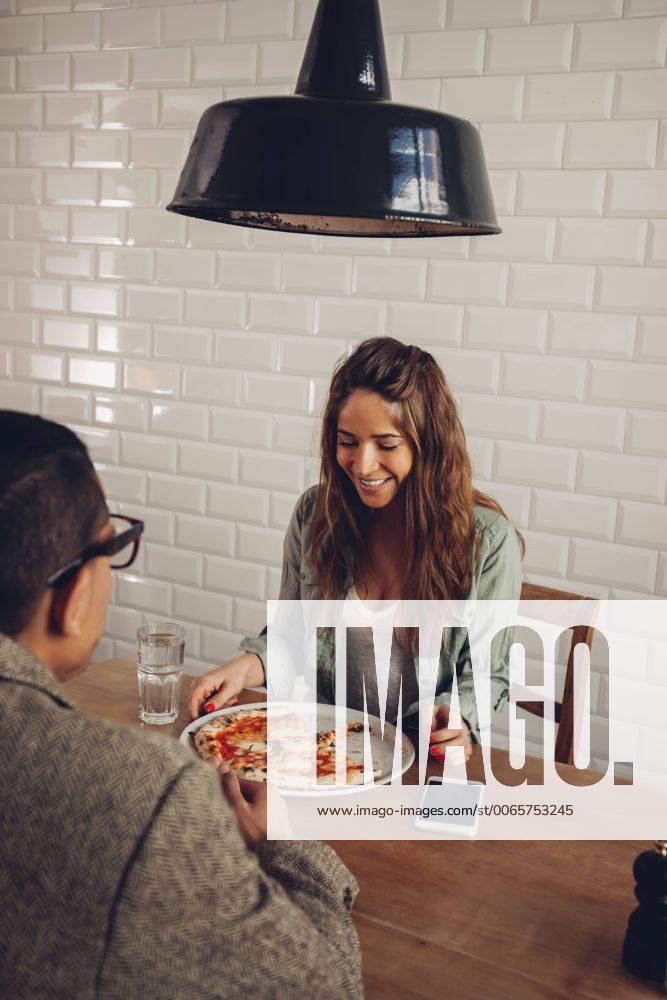 Young couple eating pizza in restaurant model released Symbolfoto property released CHAF001291