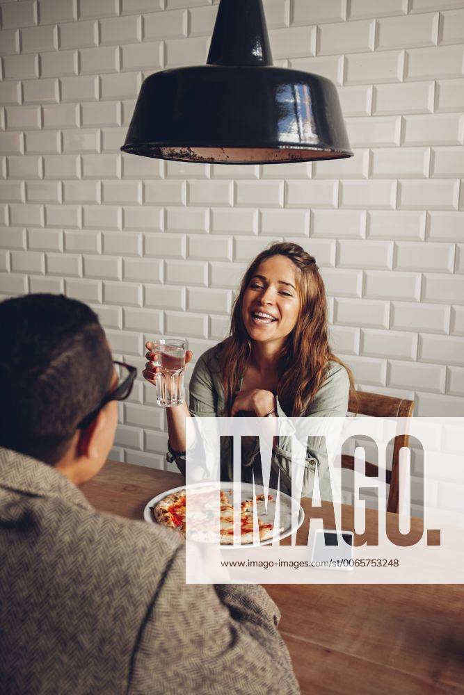 Young couple eating pizza in restaurant model released Symbolfoto property released CHAF001292