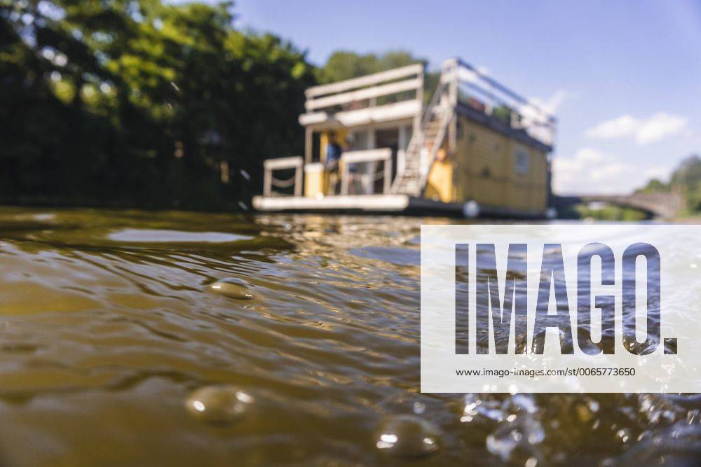 Water surface with house boat in background model released Symbolfoto property released FMKF001901