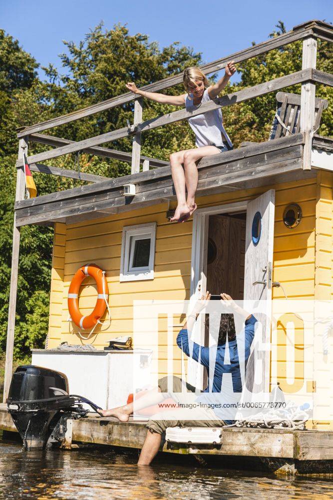 Couple having a trip on a house boat taking a picture model released Symbolfoto property released FMKF001987