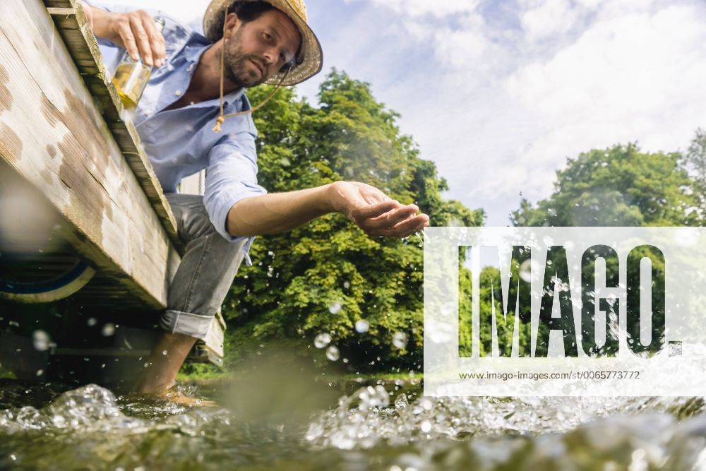 Man on a house boat refreshing himself model released Symbolfoto property released FMKF001989