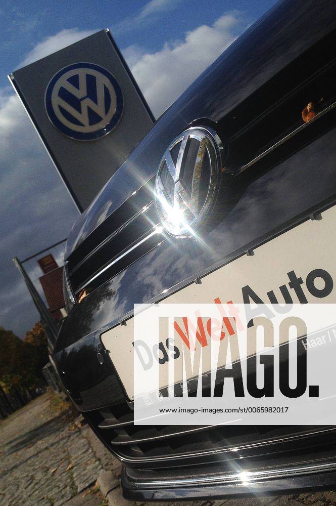 Themenbild VW Volkswagen Abgas Skandal, VW Motorhaube,Kuehlergrill VW Golf mit VW Emblem,Markenemblem,Logo mit Licht reflexionen,Slogan DAS WELT AUTO.