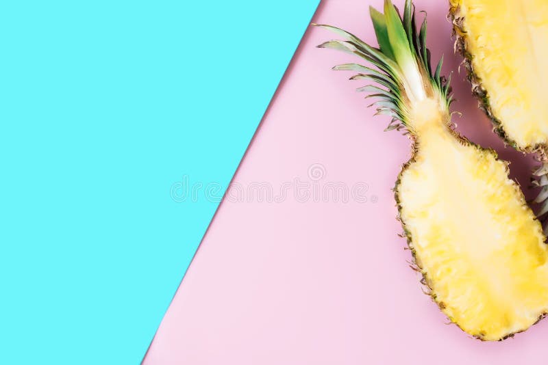 Cut halves of fresh pineapple on pastel pink and blue background. Exotic fruit, Flat lay with cut halves of fresh pineapple on a pastel pink and blue background. Ingredient for Pina Colada. Exotic fruit. High quality photo