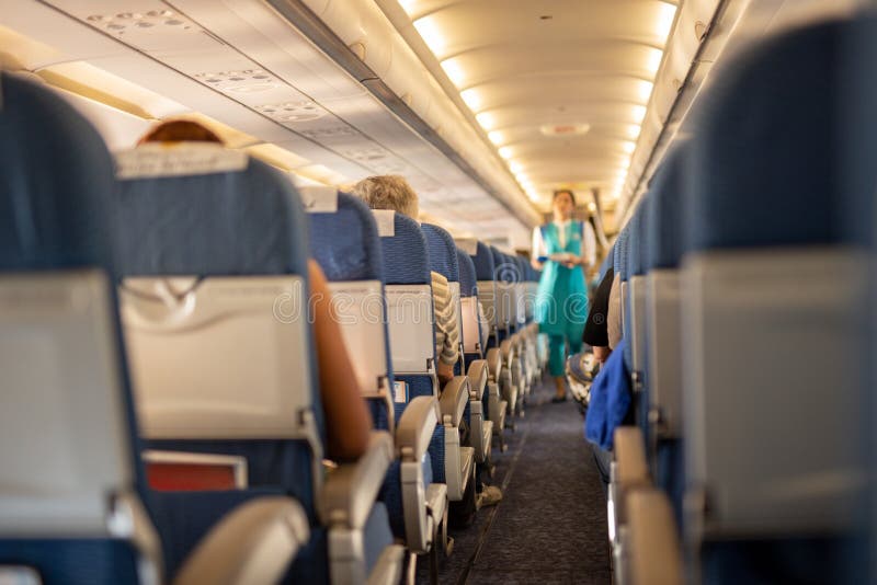 Interior of commercial airplane with passengers on their seats during flight., Interior of commercial airplane with passengers on their seats during flight