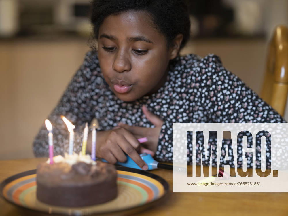 Girl blowing out candles on birthday cake model released