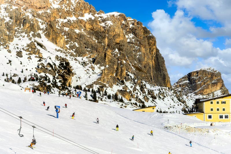 Wolkenstein in Groeden in winter with chairlift and skiers, Dolomite, Italy, Wolkenstein in Gröden in winter with chairlift and skiers, Dolomite, Italy
