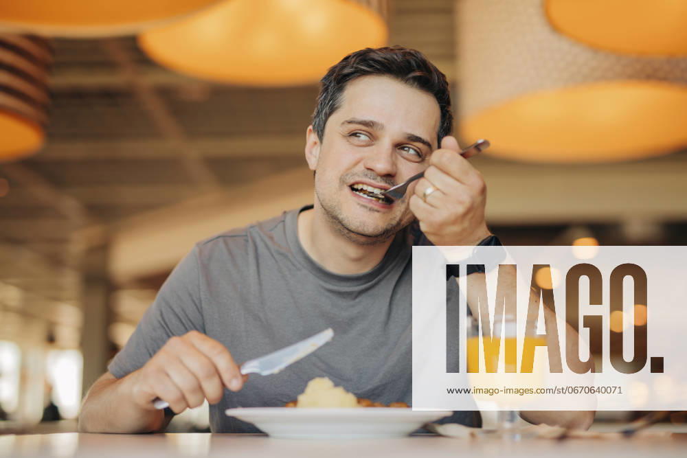 Happy man having breakfast at cafe model released, Symbolfoto, VSNF02029
