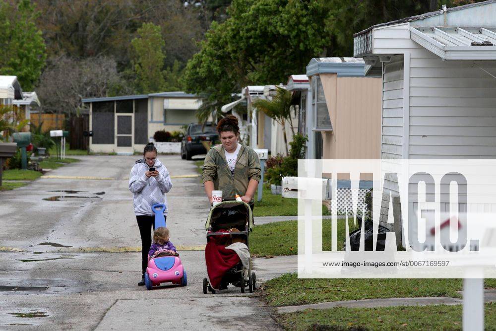 Palm Harbor, Florida, U.S. - DOUGLAS R. CLIFFORD.A pair of young mothers walk with their children on Friday (3 7 14) in the Frontier Village Mobile Home Park, 30700 US Hwy 19, Palm Harbor, where they live. They are among the residents who say they are worried about a rash of fires in the park, including two overnight fires at two separate mobil homes in the park. - ZUMAs70