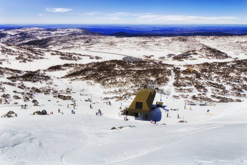 SM Back Perish Mt Down 2 Town, From the peak of Mt Back Perisher high in Snowy Mountains of Australia looking down to chairlift station for snowboarders and skiers above Perisher valley snow fields and ski resort slopes.