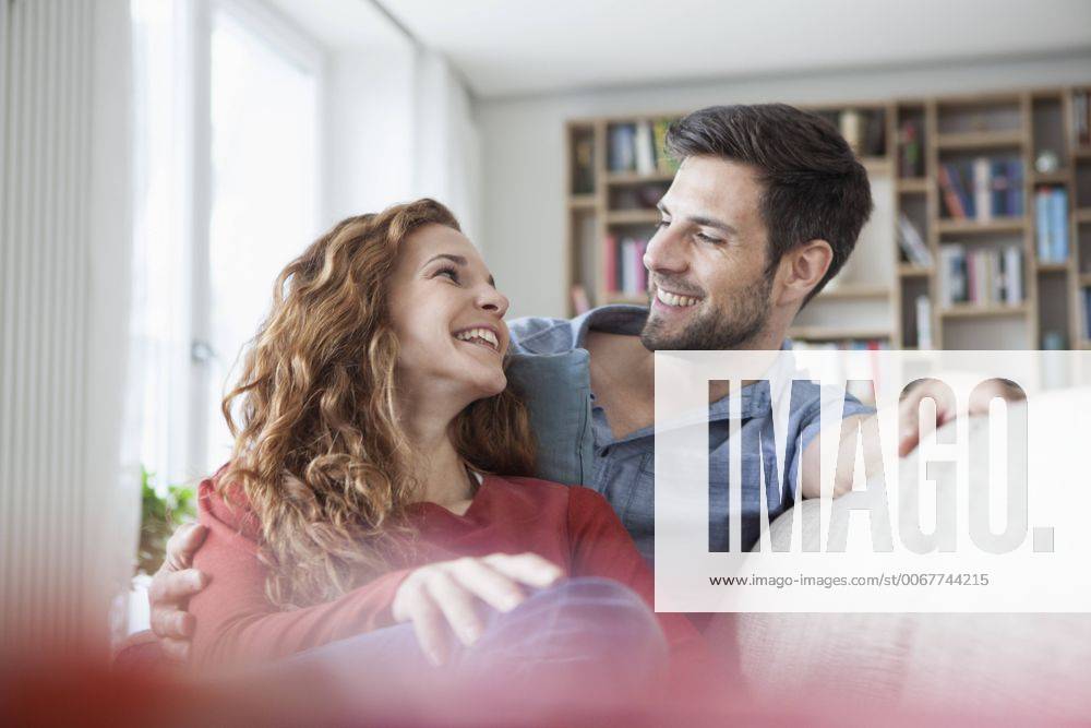 Relaxed couple at home on couch model released Symbolfoto property released RBF003539