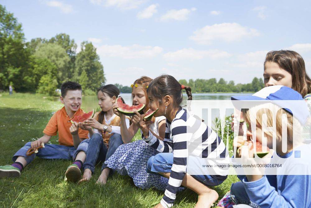 Children enjoying slices of watermelon at picnic, Munich, Bavaria, Germany mit_2017_00342