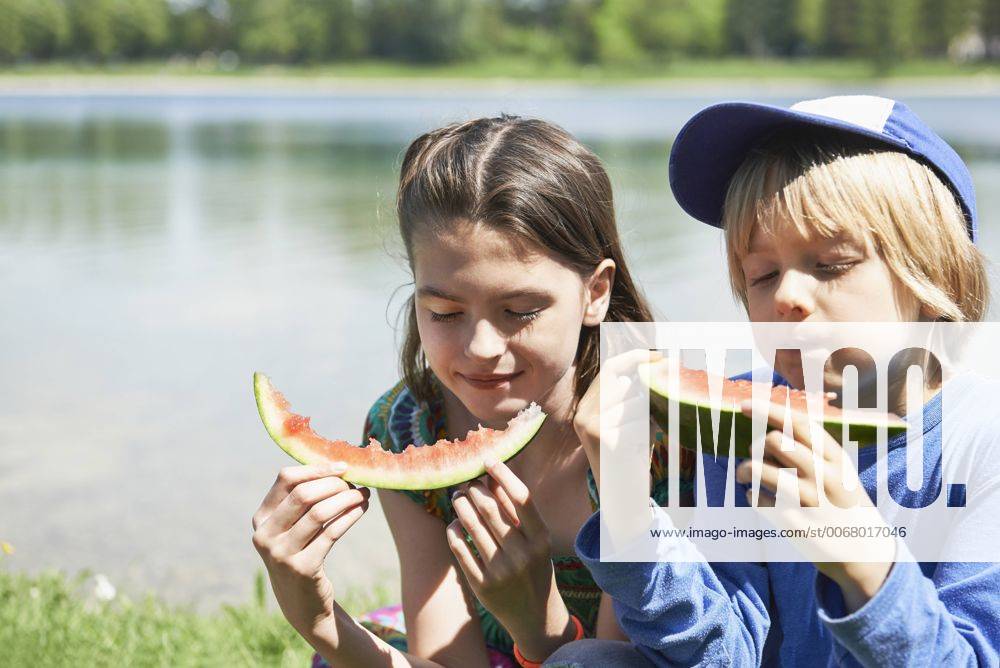 Children enjoying slices of watermelon at picnic, Munich, Bavaria, Germany mit_2017_00347