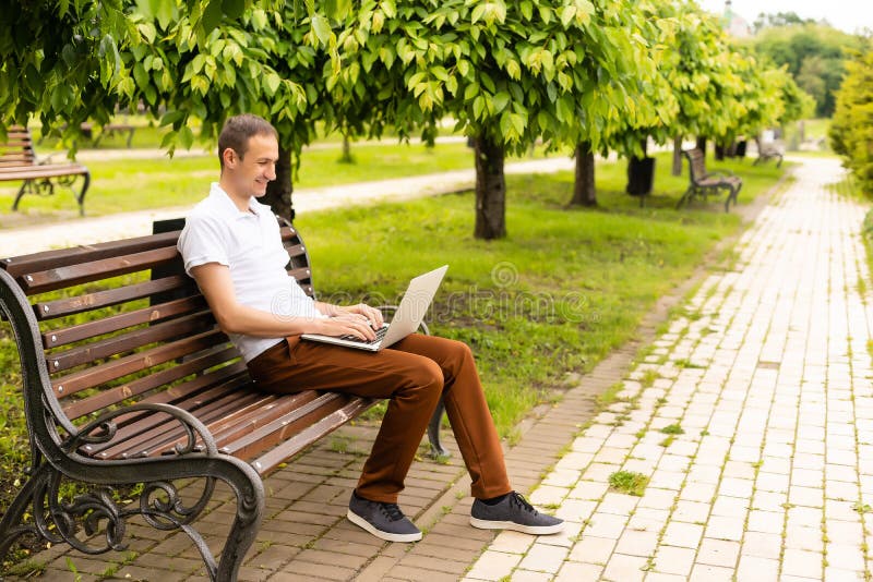 Man working on his laptop in the park, Man working on his laptop in the model released