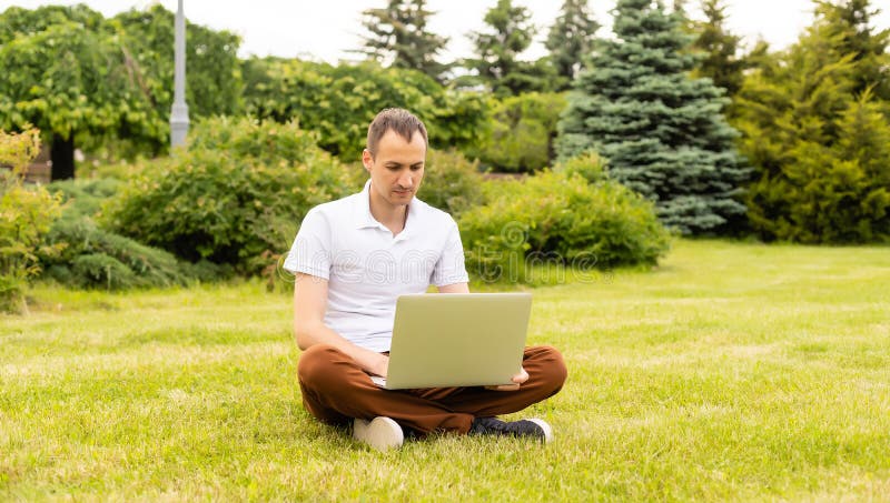 Man working on his laptop in the park, Man working on his laptop in the model released